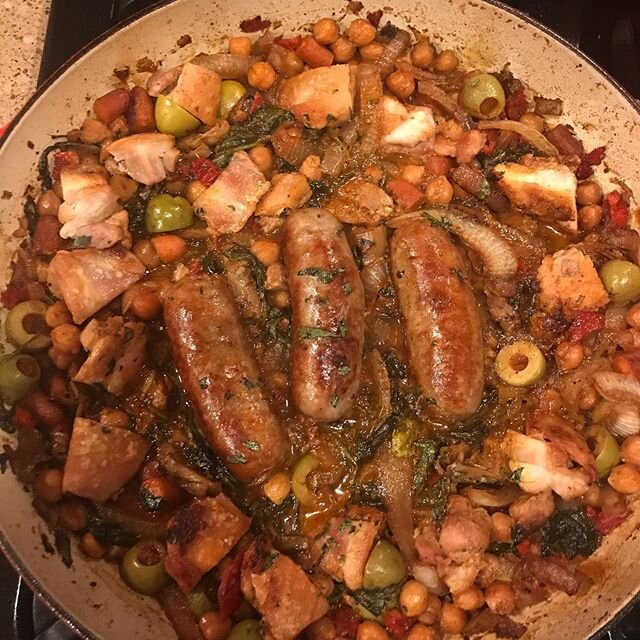 Braised chicken and sausage with chickpeas, sun dried tomatoes, olives, artichokes and preserved lemon over cauliflower rice and topped with pandemic grown herbs #pantryandfridge
