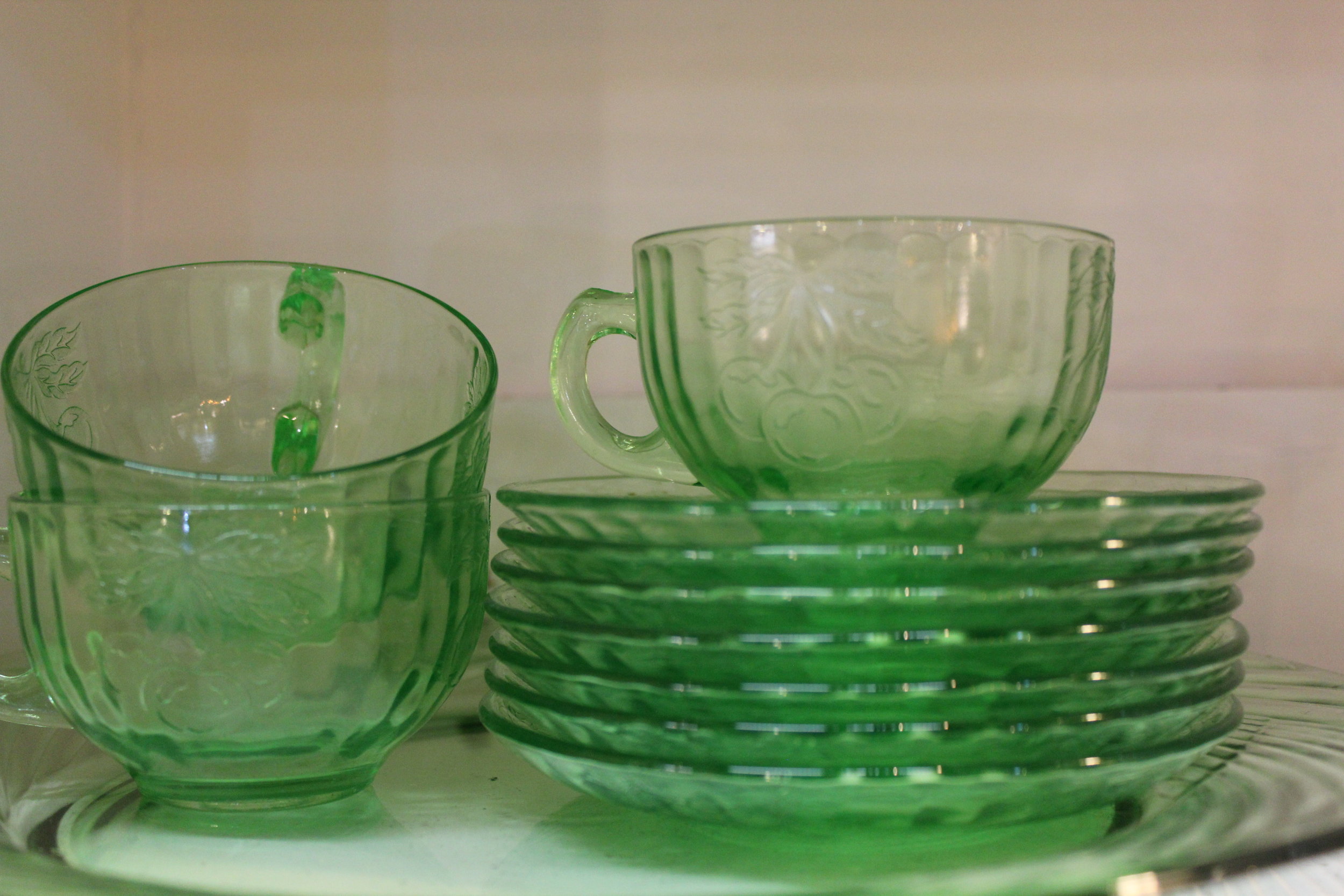 Green depression glass plates and cups