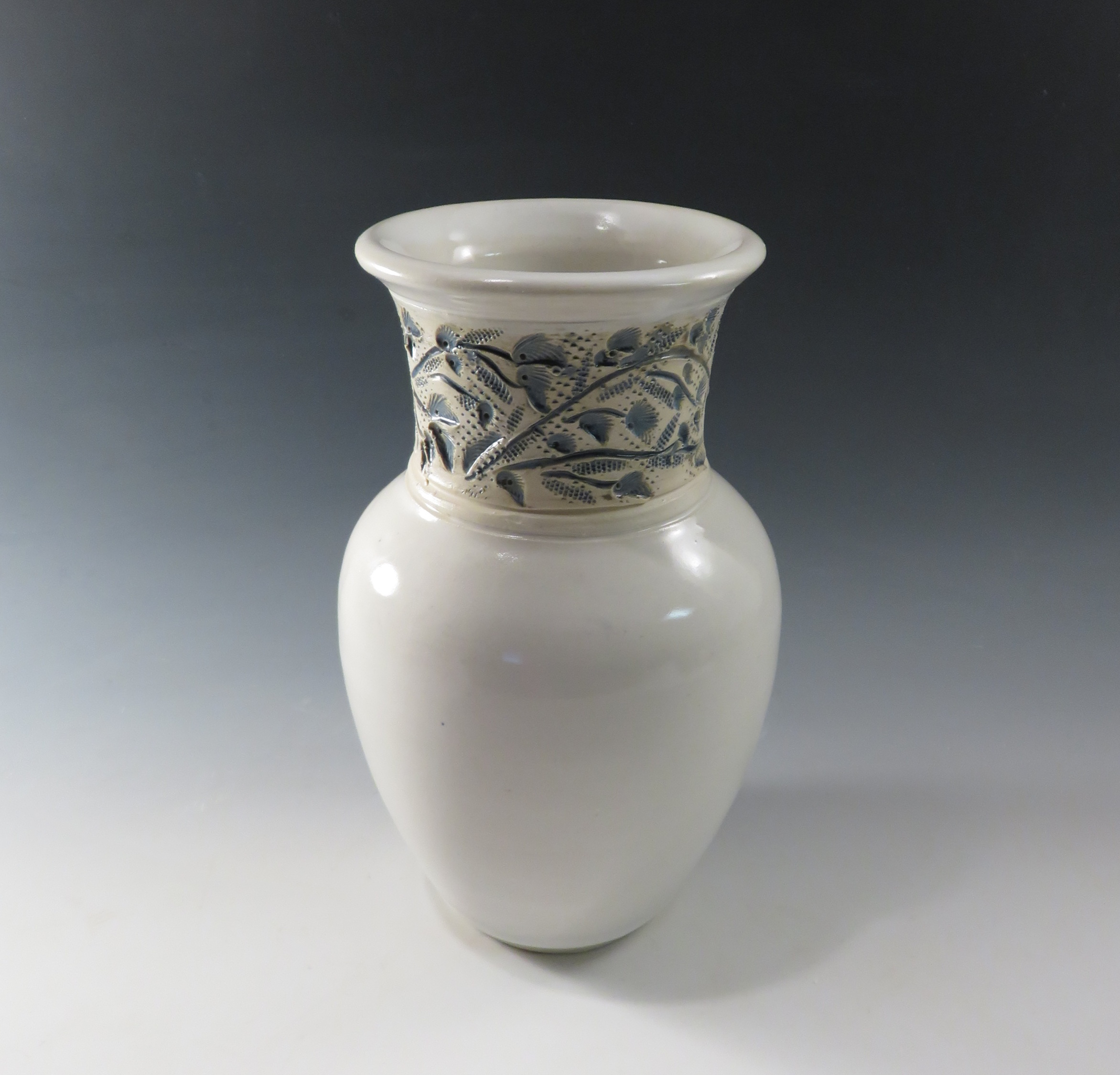 White vase with blue flowered neck