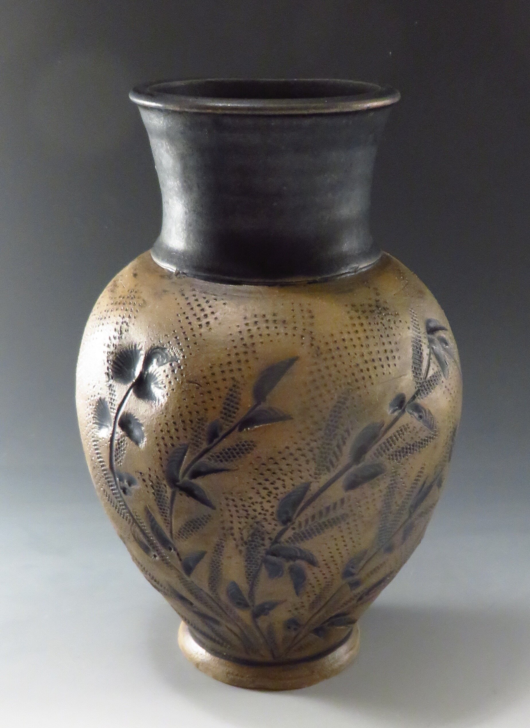  Carved and stamped black and brown vase 