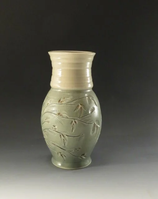 9” green vase with flowered base w orange.