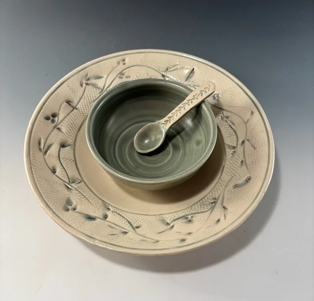 Chip and dip: 9” White stoneware plate with incised flowered vine. 4” green bowl with hand built spoon . McGuire green glaze.