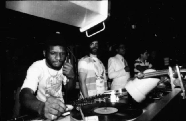Larry Levan at the Paradise Garage with David Mancuso (centre) and Herbie Hancock (right). Courtesy of Gail Bruesewitz.