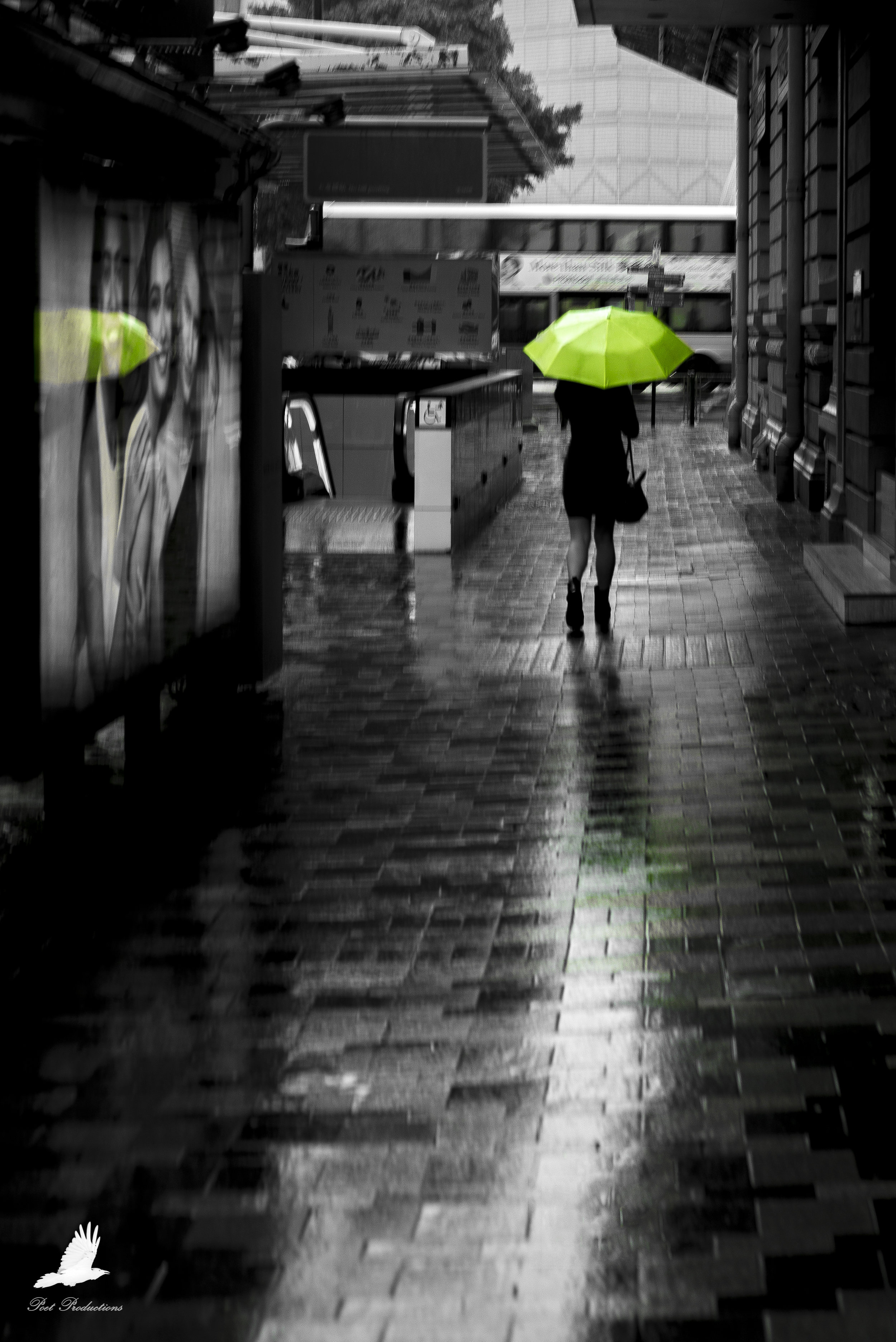 Woman with a lime green umbrella in Hong Kong