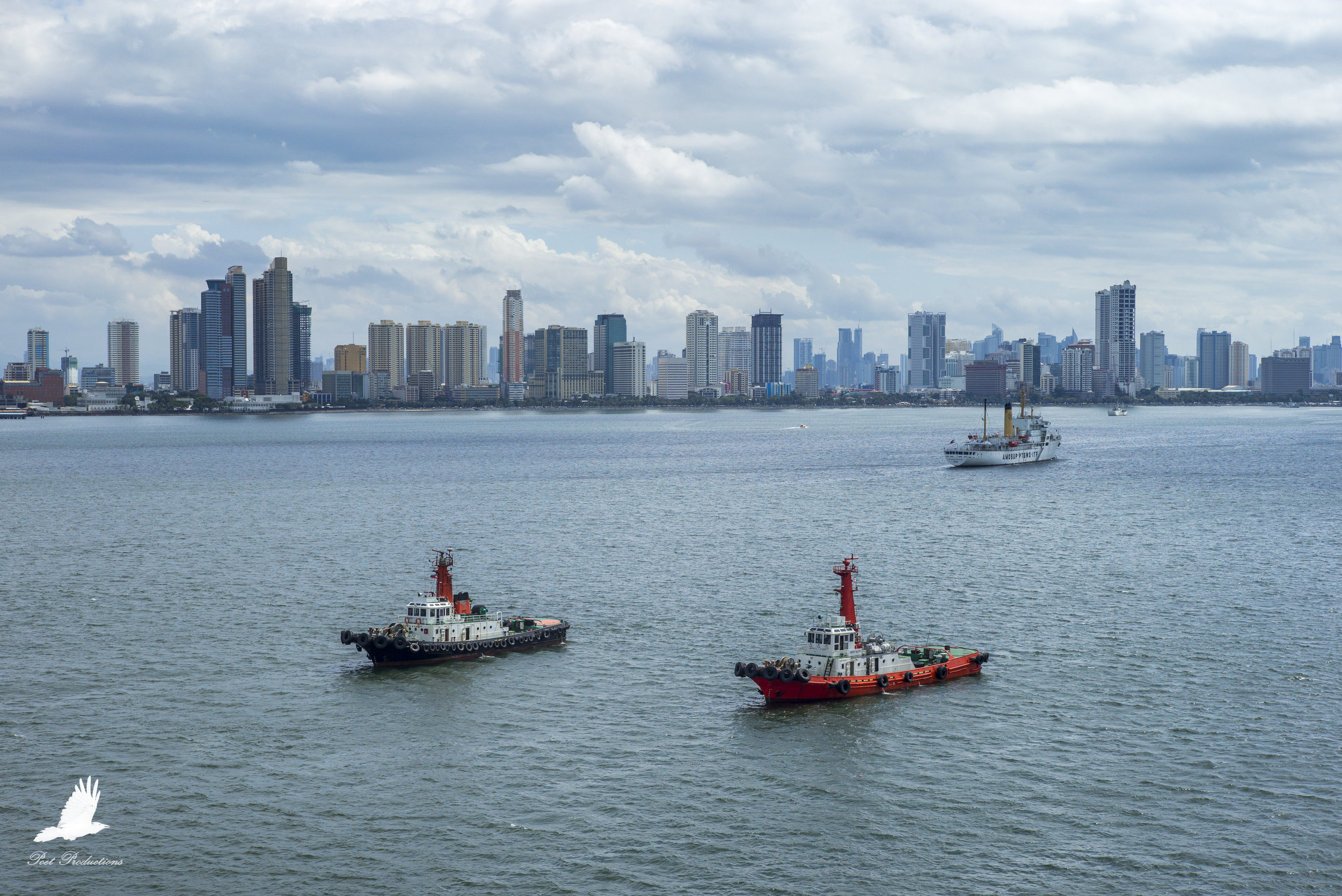 Tug boats await our arrival at Manilla