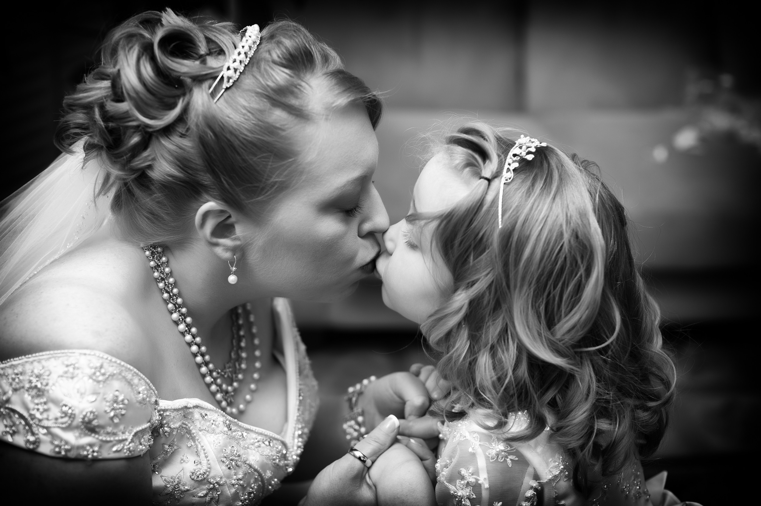 A Bride Kisses her Daughter the Flower girl on her wedding day, Kenneth Light Studios - Peter Farrar