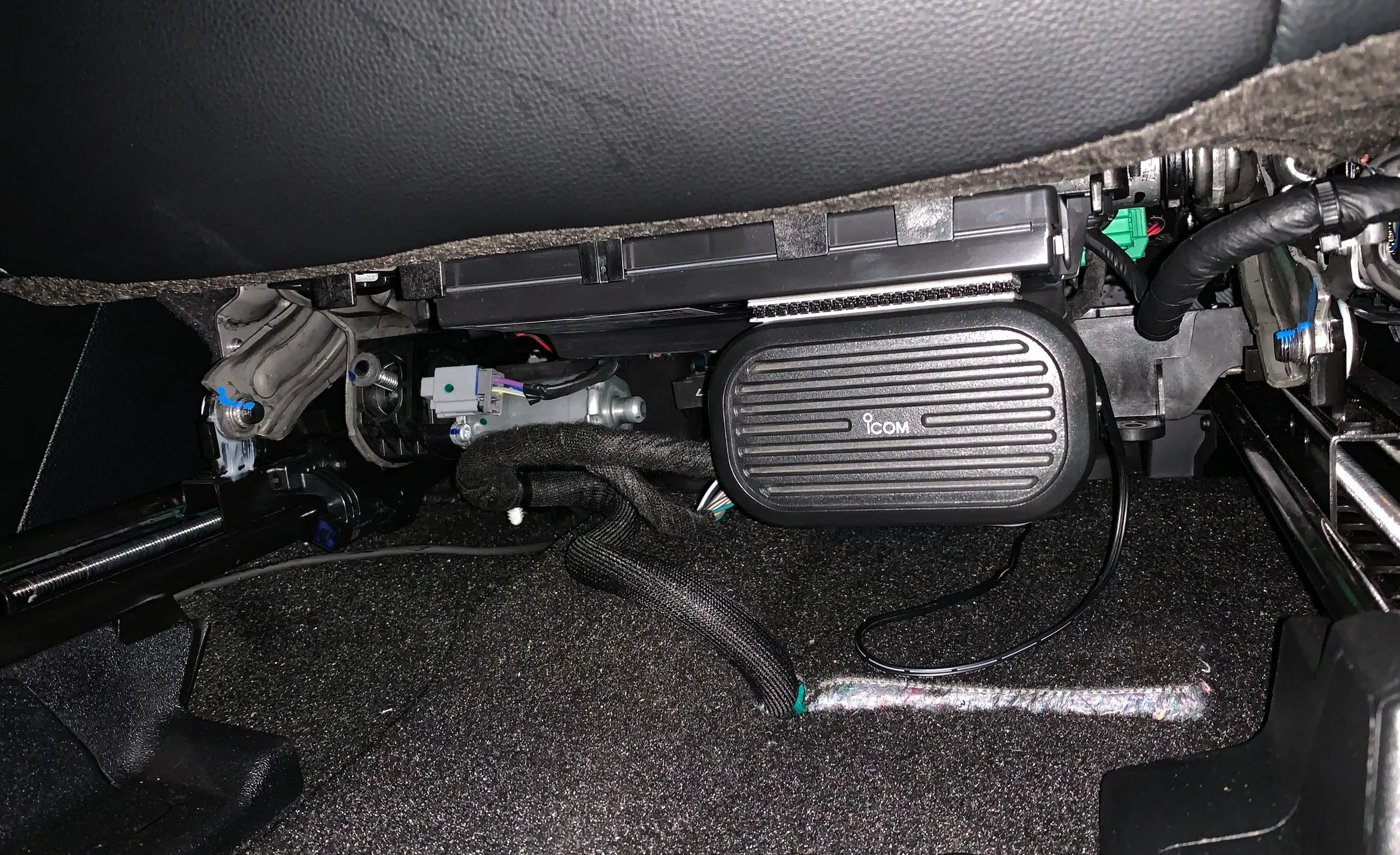 ICOM stereo speaker mounted via industrial grade velcro to the bottom of the driver seat. This allows the speaker to move forward and back.