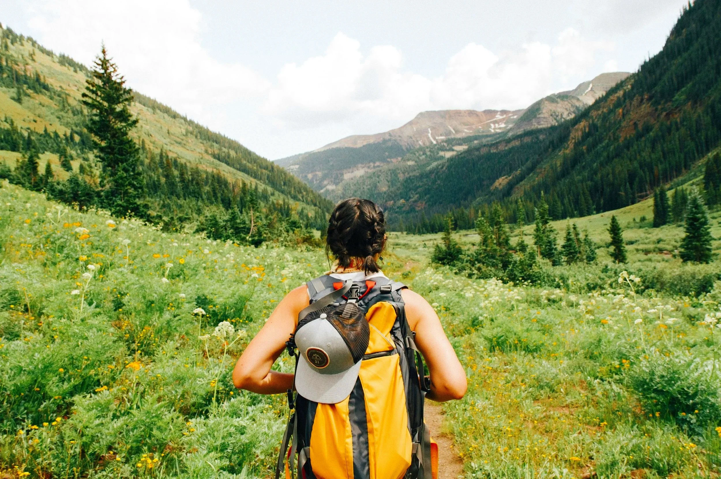 Person hiking through a mountain valley