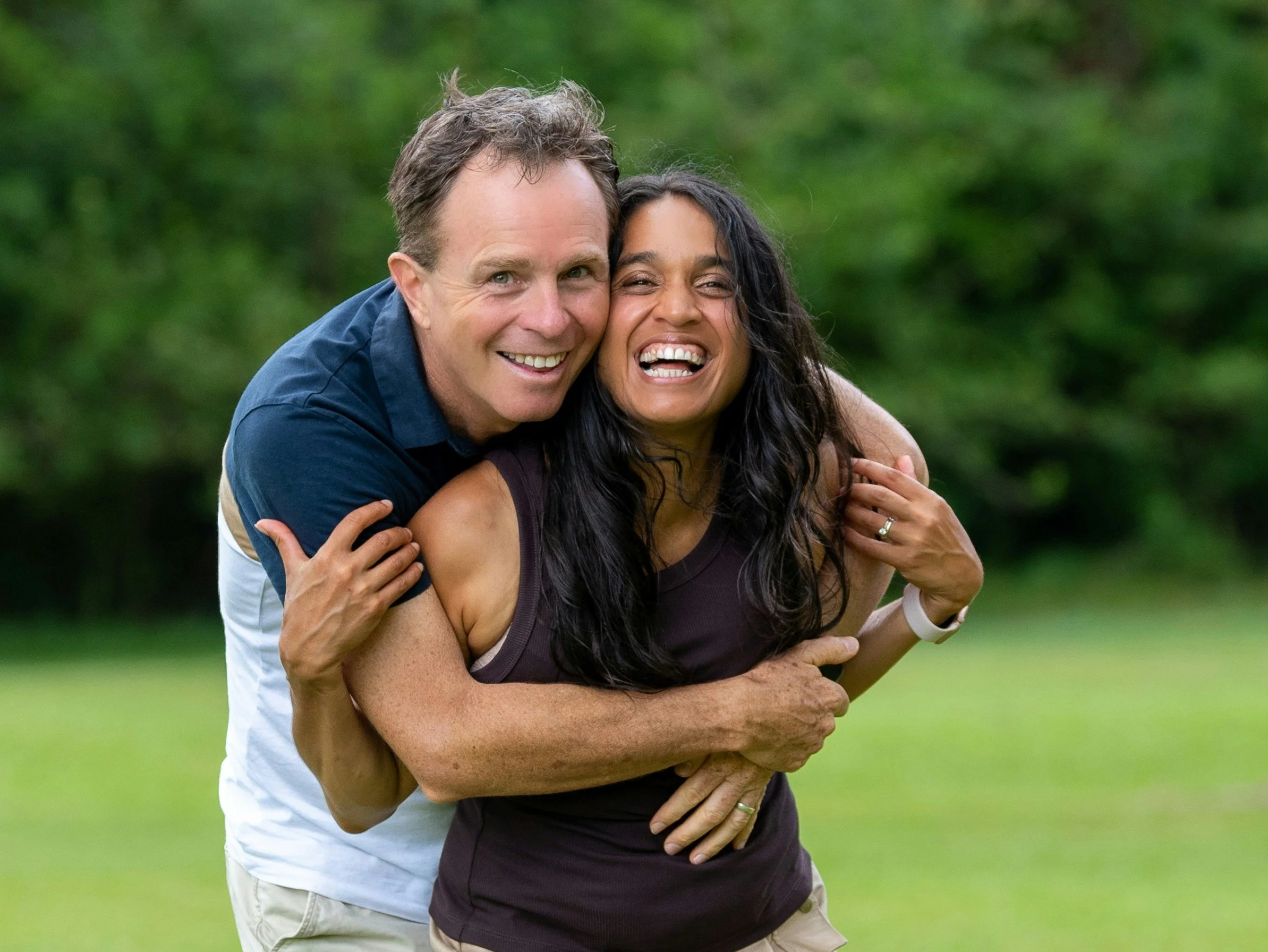 Couple smiling and embracing outdoors