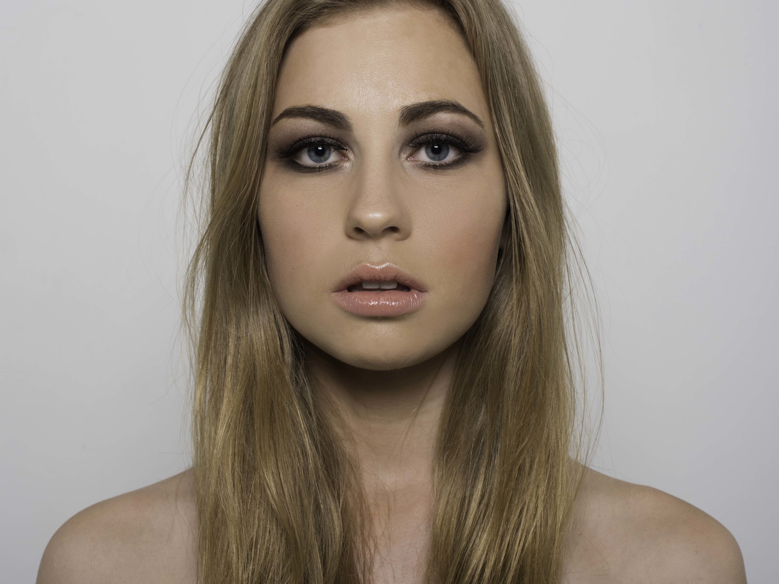 Jenny photographed with the same V-Flat, high key lighting setup, but with only the key light used.