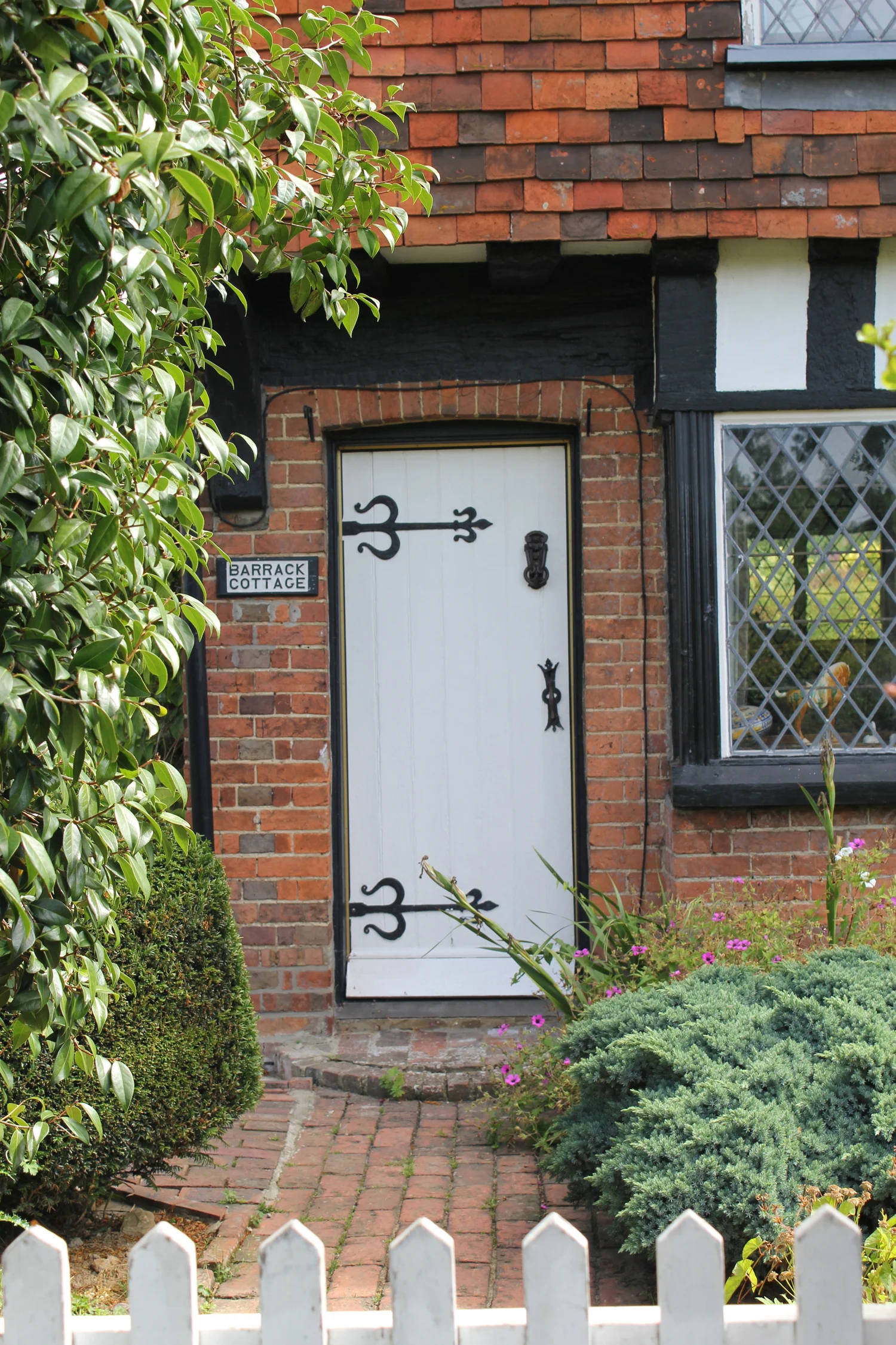 Timber front door with iron detail hinges 