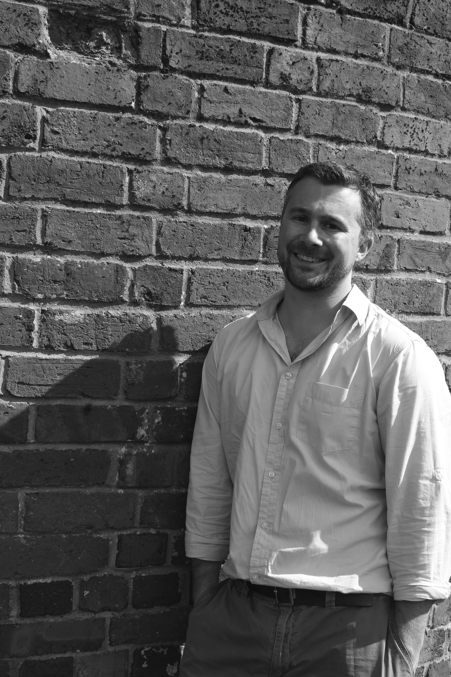Birmingham architect Ben Mainwood with brick wall