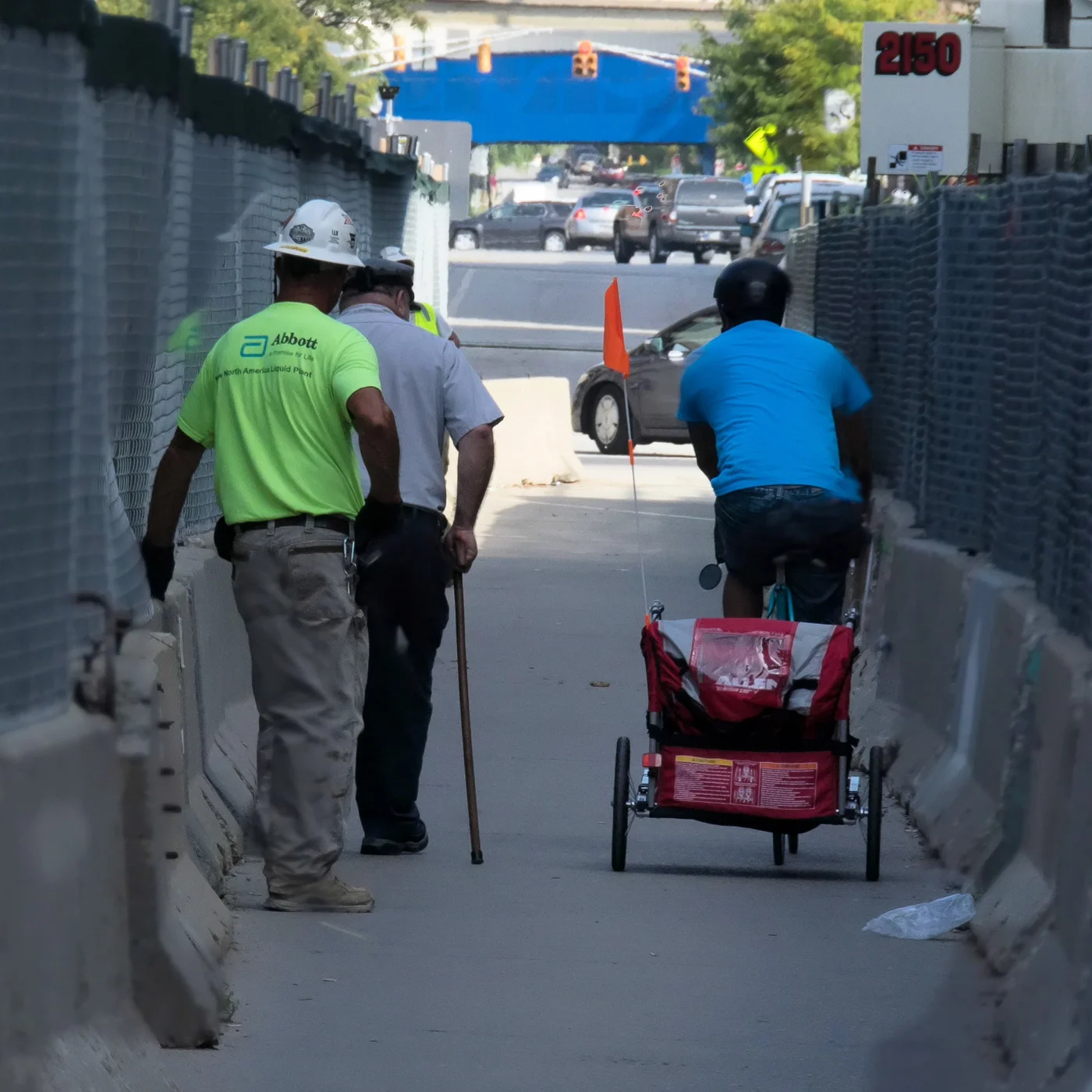 The guy in the blue shirt was pulling a bike trailer. He was in a hurry and when he passed me I was surprised to see a baby inside. What an exciting ride for the baby!
