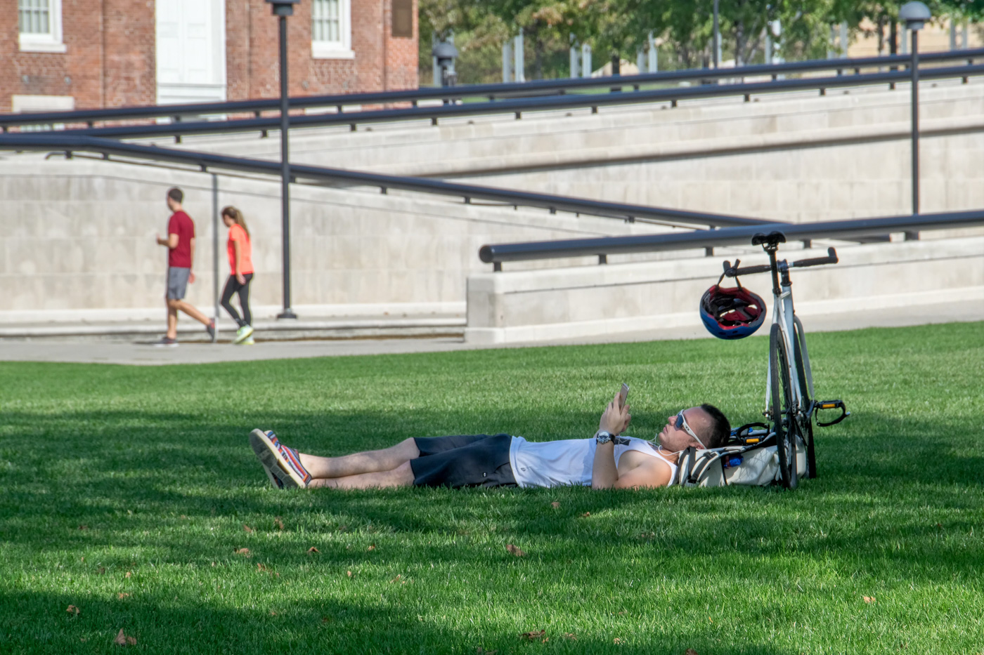 A cyclist stops to relax and read at White River State Park.