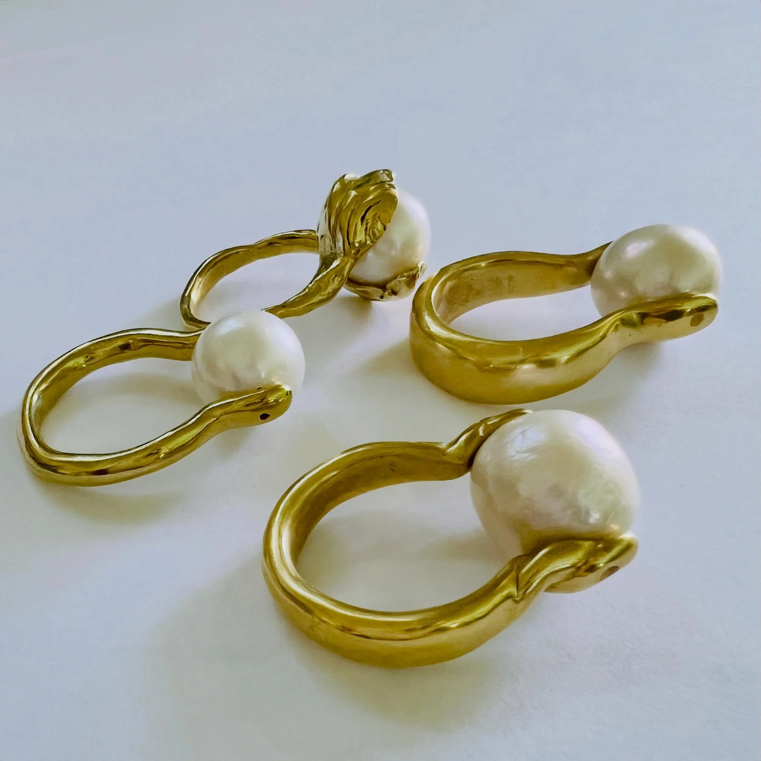 My fab four. 💖 The chunky pearl ring In foreground has been a staple for a few years now. The twist band was added last year. The thin pearl band is a new iteration of the original. It makes a statement on its own but stacks nicely with other bands 