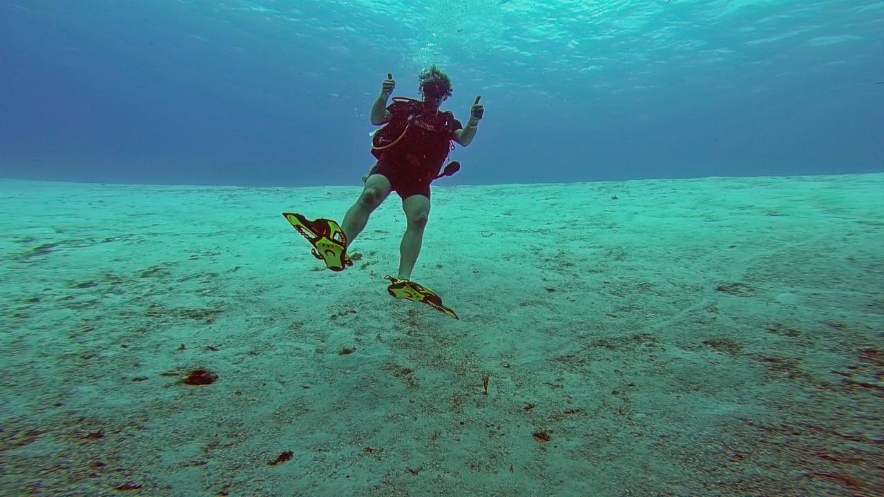 Thumbs up at sea bottom