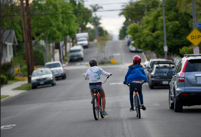 Two young girls on the Vista Bike Blvd. in Long Beach riding home from school. With the new law going into effect September 16th motorists will need to give bicyclists a space of at least three feet when passing. Image by Allan Crawford.