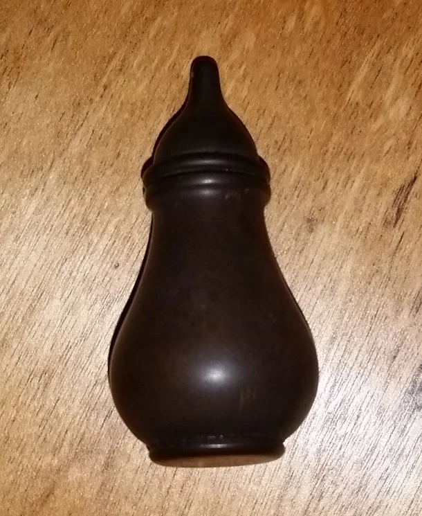 Mystery item - Approximately 1" (2.5cm) high. The top screws off with a tube going down the centre of the item. The top of the item has a hole which allowed something to come out of the container. 