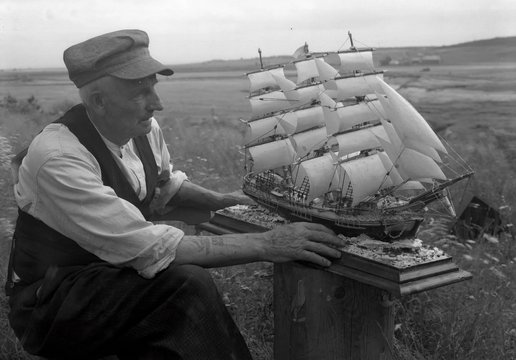Mr. J. H. Sherwood looking at his model sail ship "Lightning", 1938. From New Brunswick Archives P93-AL-06