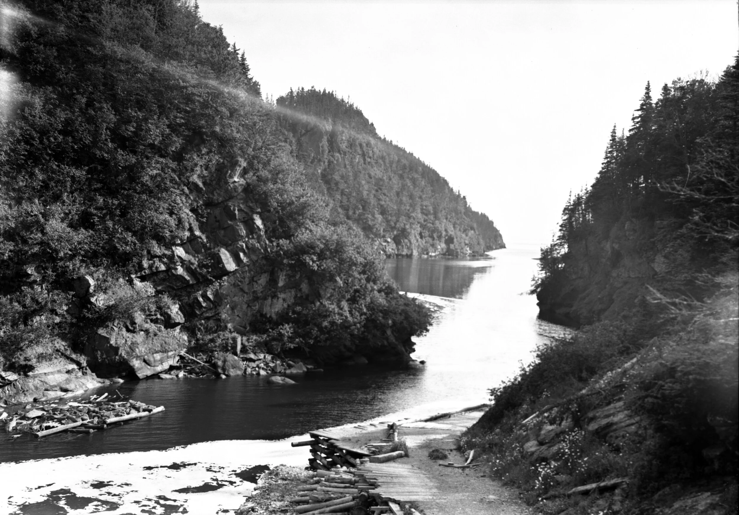 Inlet with high banks covered with trees on each side, Point Wolfe, 1940. From New Brunswick Provincial Archives P93-AL-27.