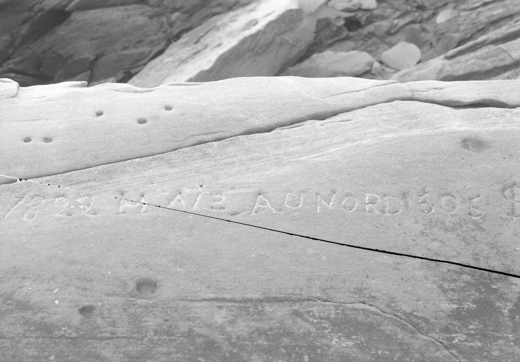 Inscription "1822 Maib Aunord 1505" on rock at Mary's Point, 1936., From Library and Archives New Brunswick