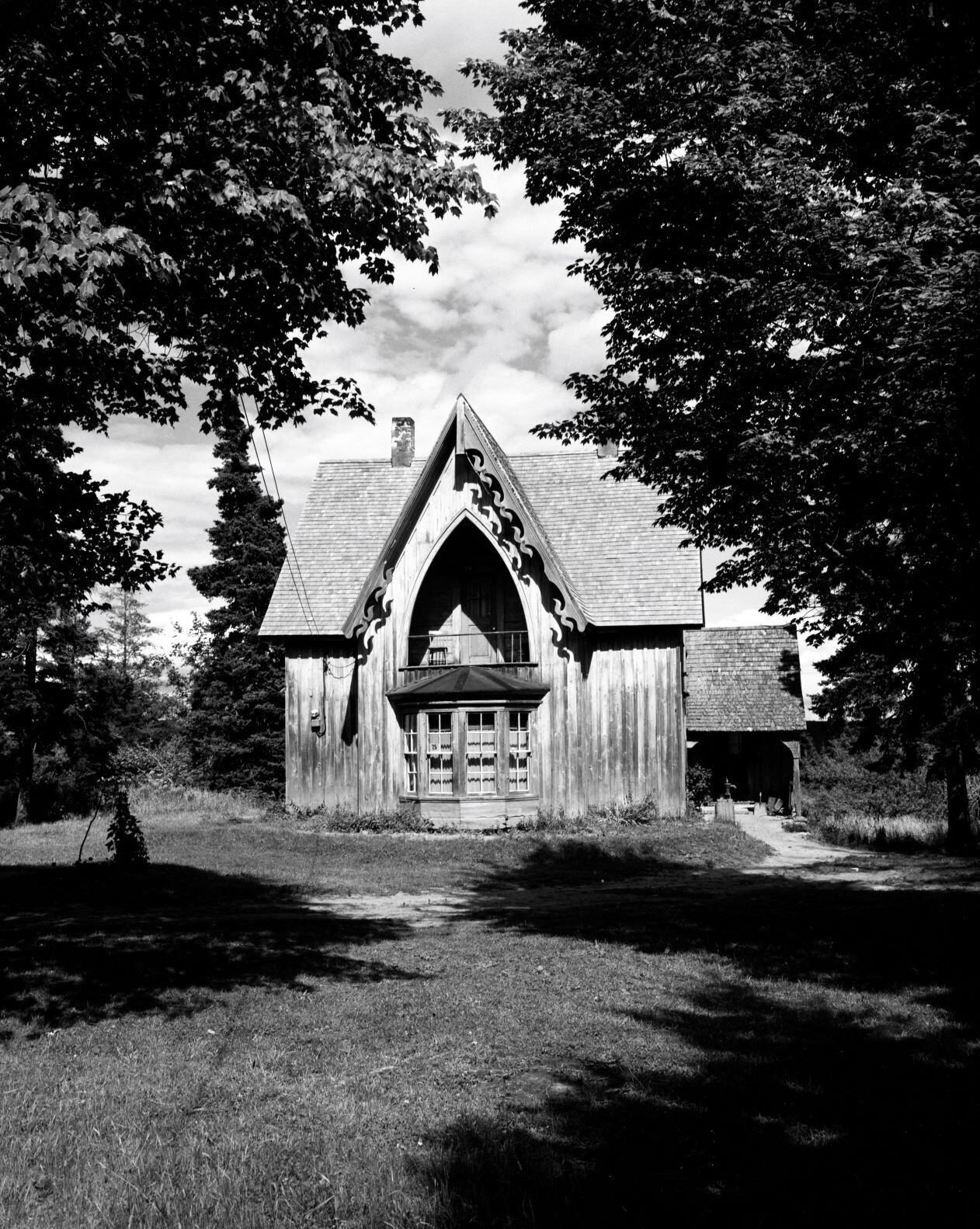 Two storey wooden house with a large Gothic arch window in front on second floor, &nbsp; c.1950.. From Archives New Brunswick. P93-AL-84