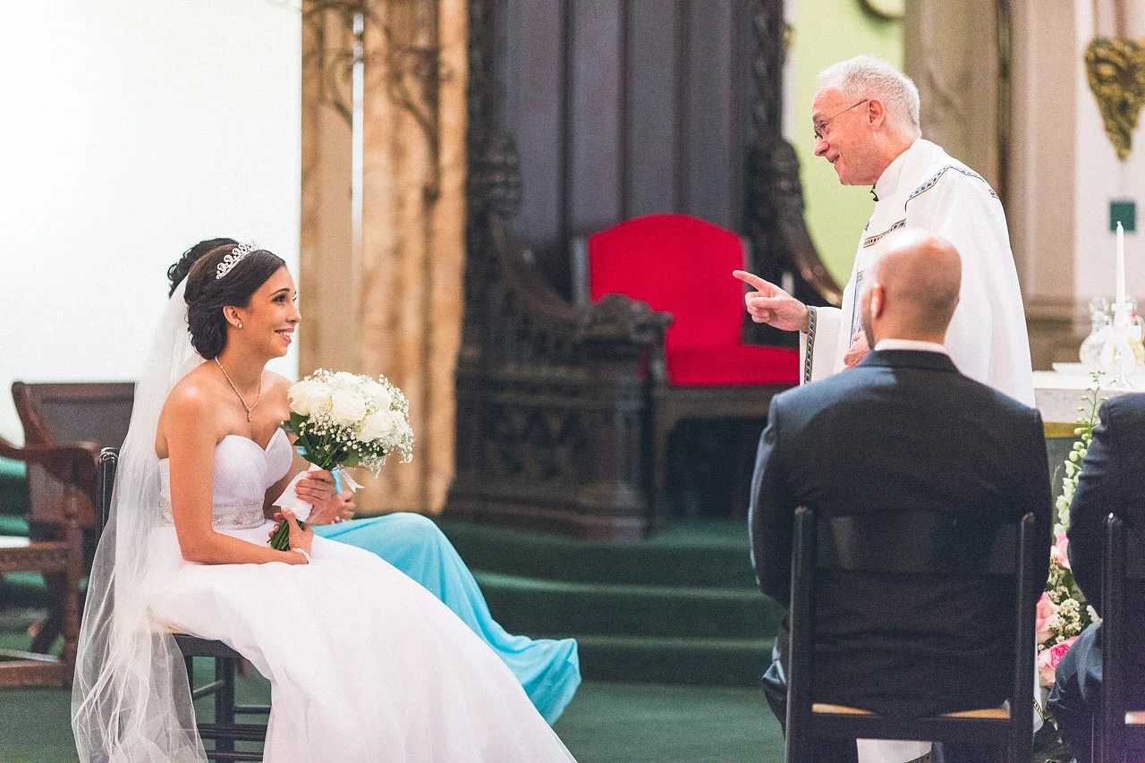 Bride laughs with Priest