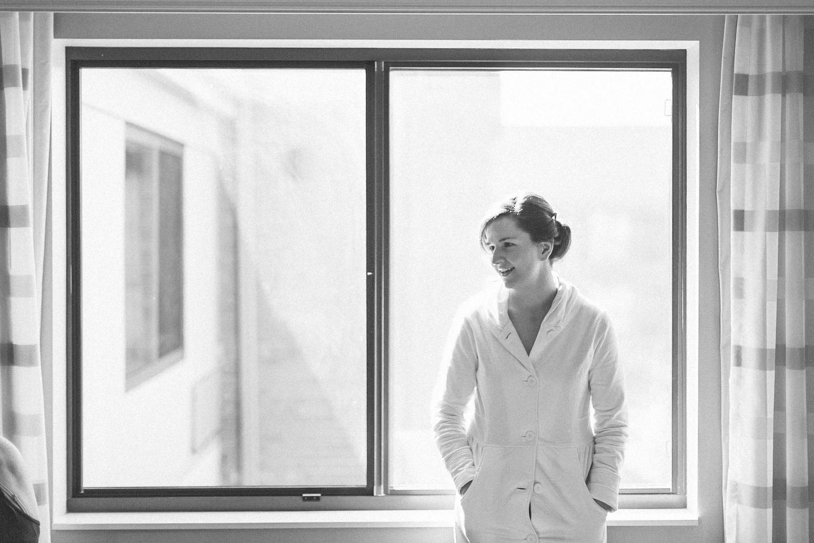Bride waits to put dress on