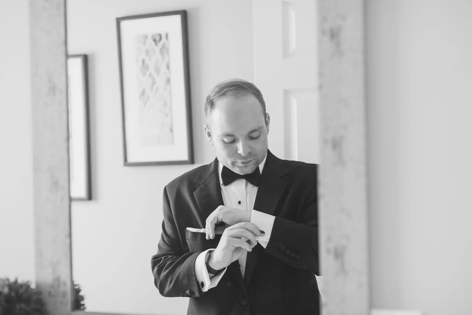 Groom adjusting cuff links