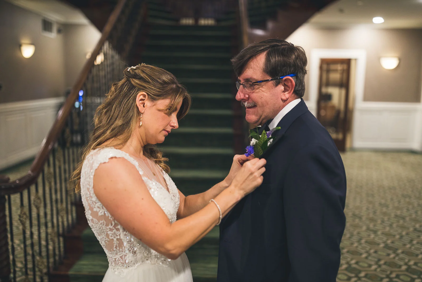 Bride puts boutineer on father