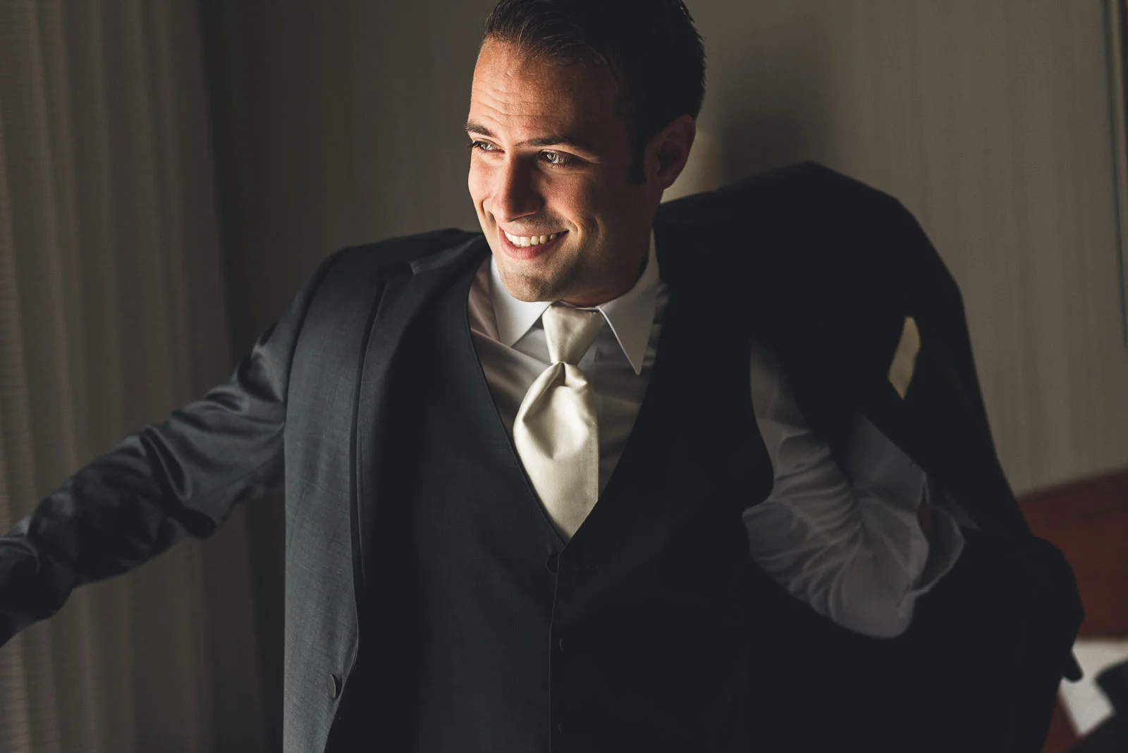 Groom puts on jacket