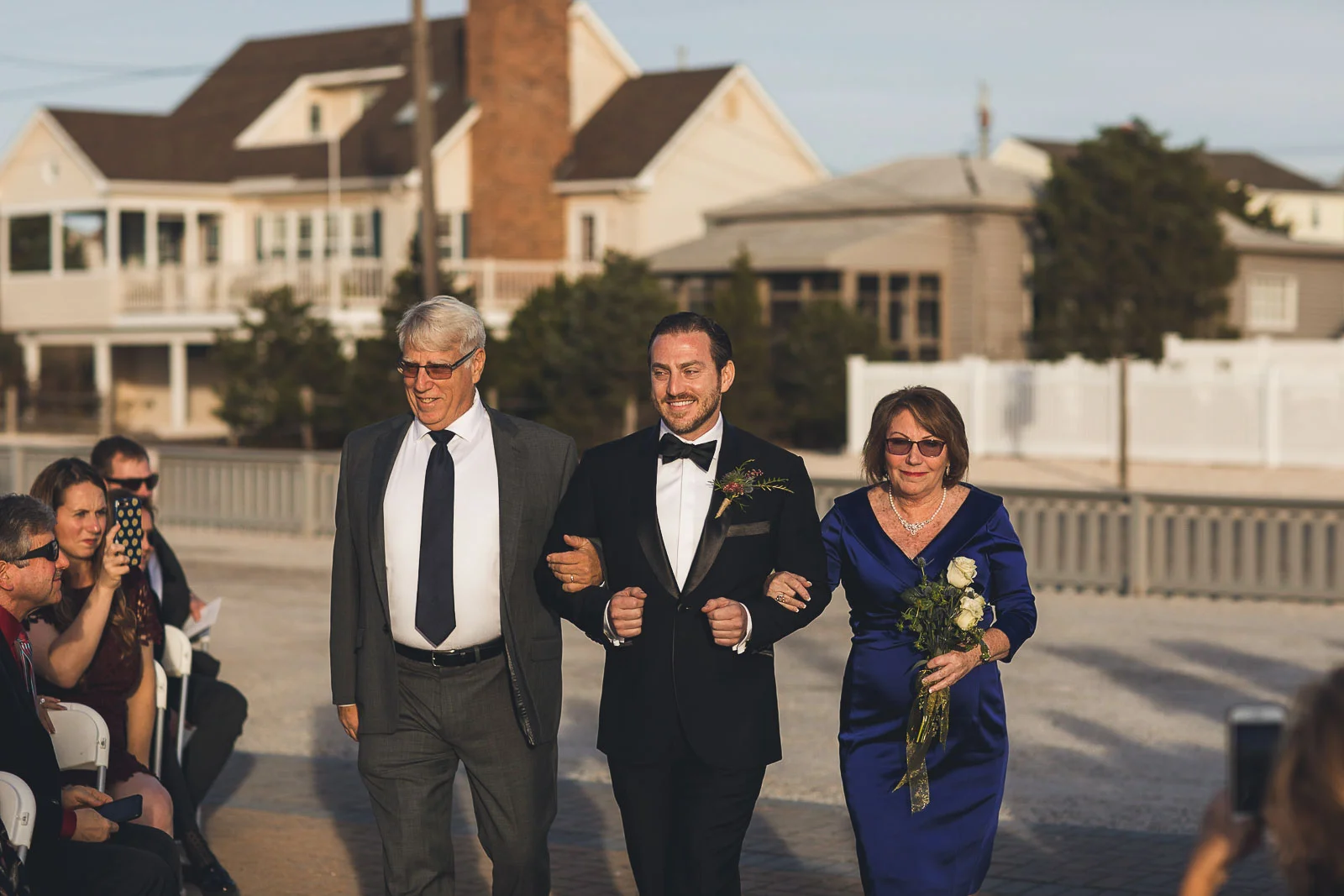 Parents walk Groom down aisle