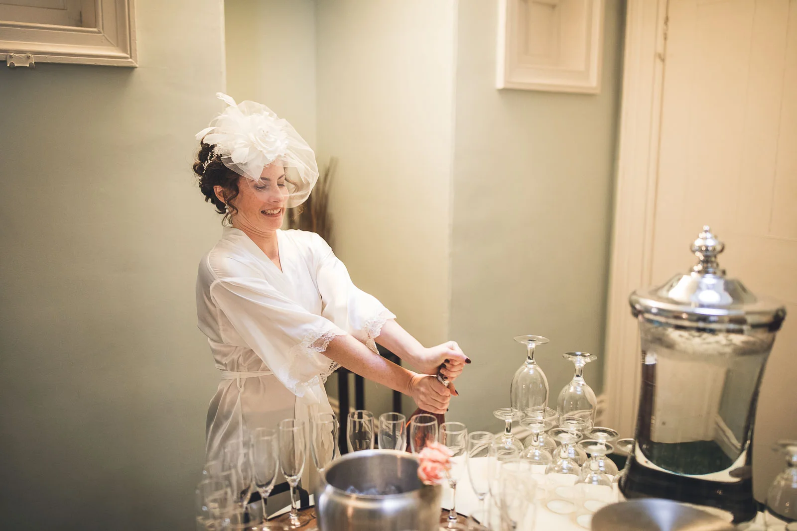 Bride popping some champagne wedding photography