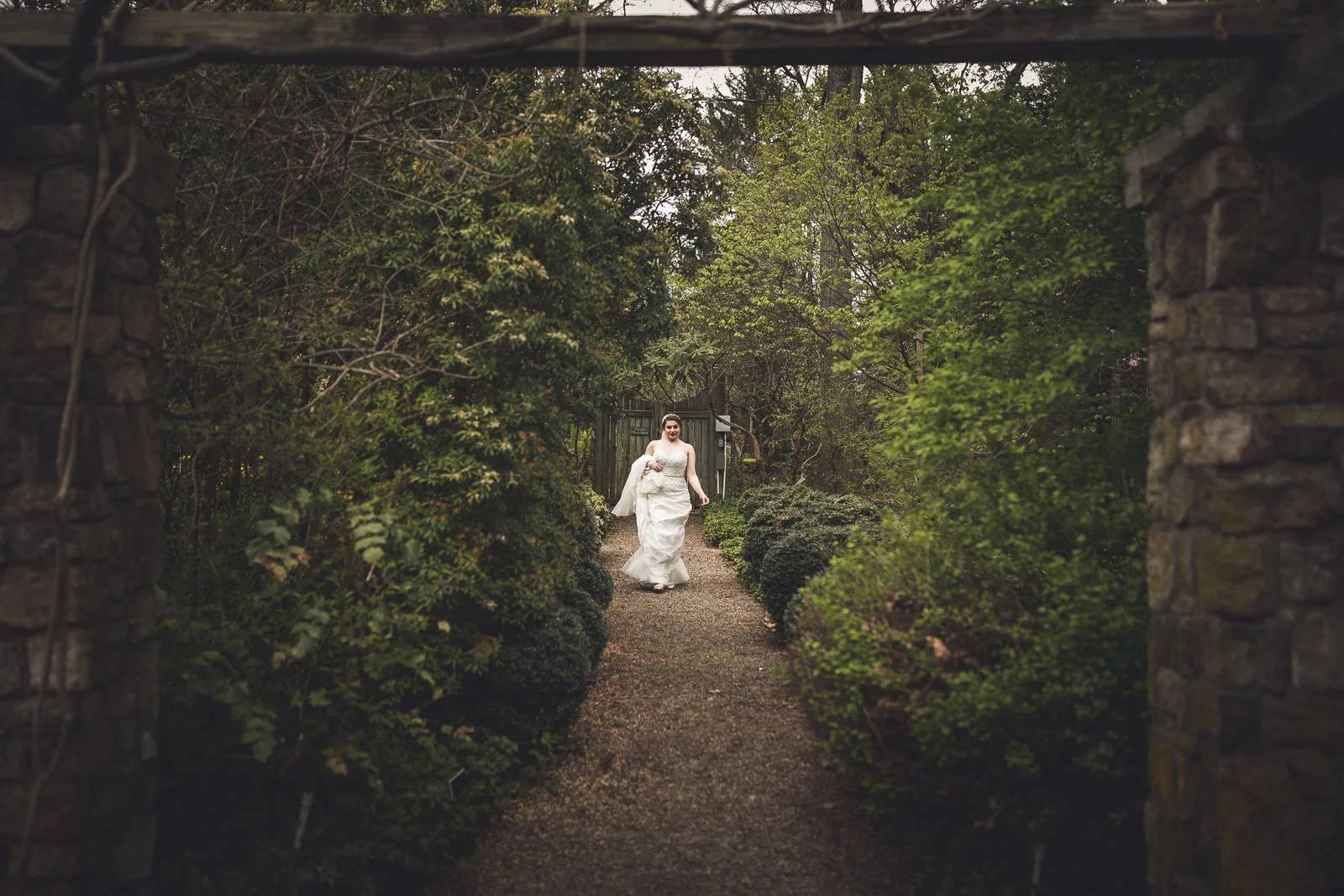 Bride walking to first look Cross Estate Gardens