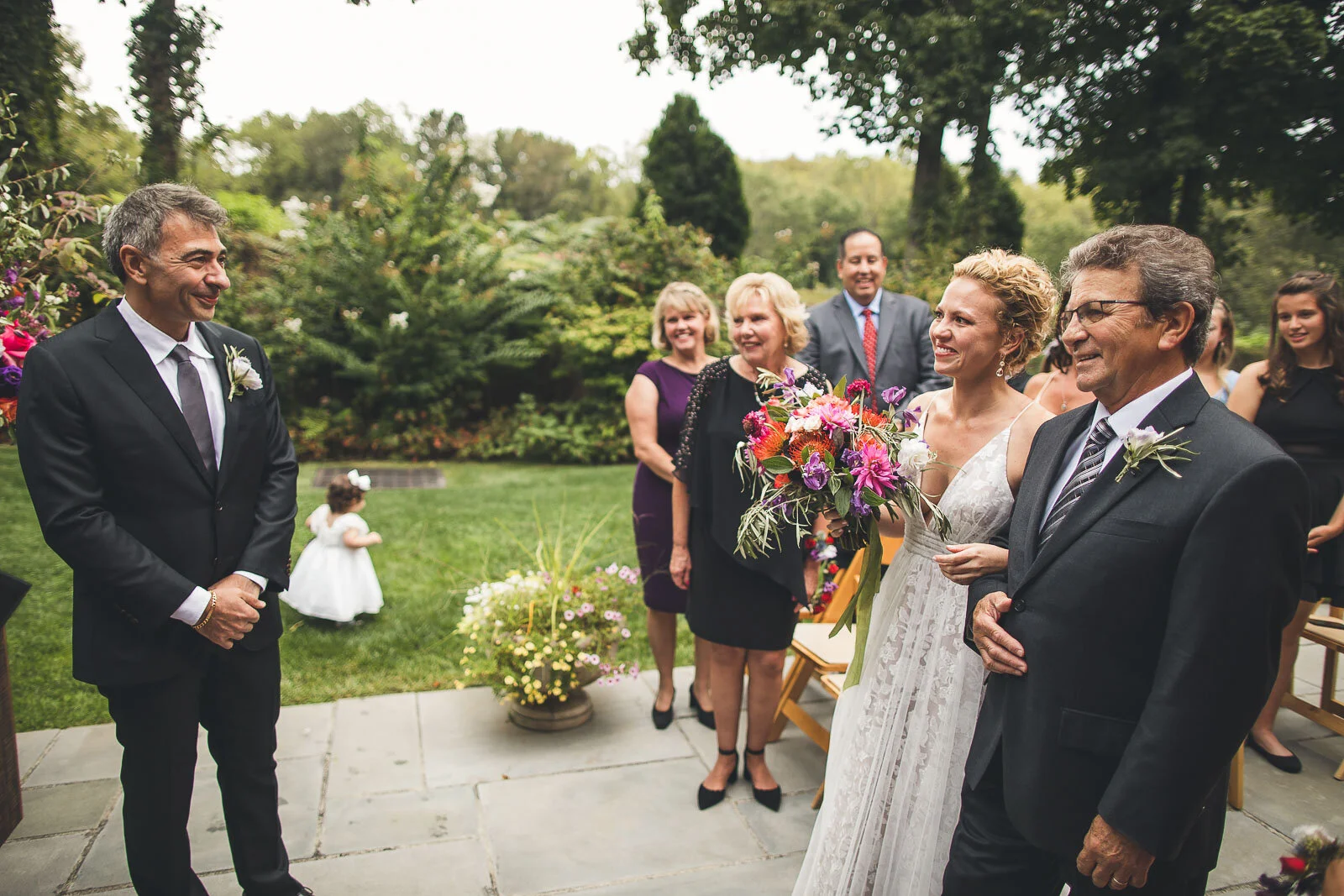 Father walks bride down the aisle.