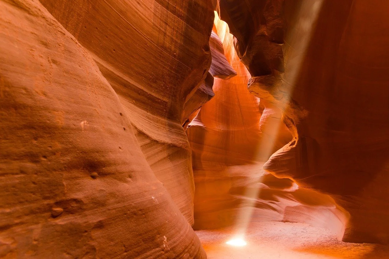 Photo of beam of white light shining down into Antelope Canyon red rocks geological feature by tegawi from Pixabay