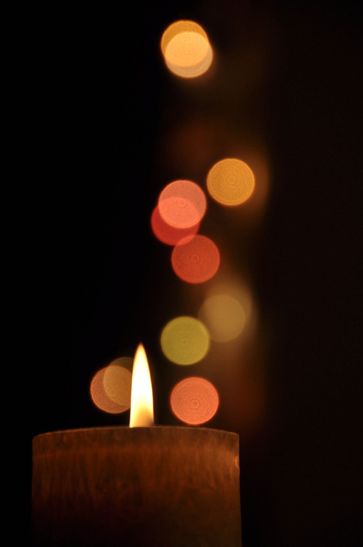 Photo of candle flame in bokeh light by Raventhorne from Pixabay