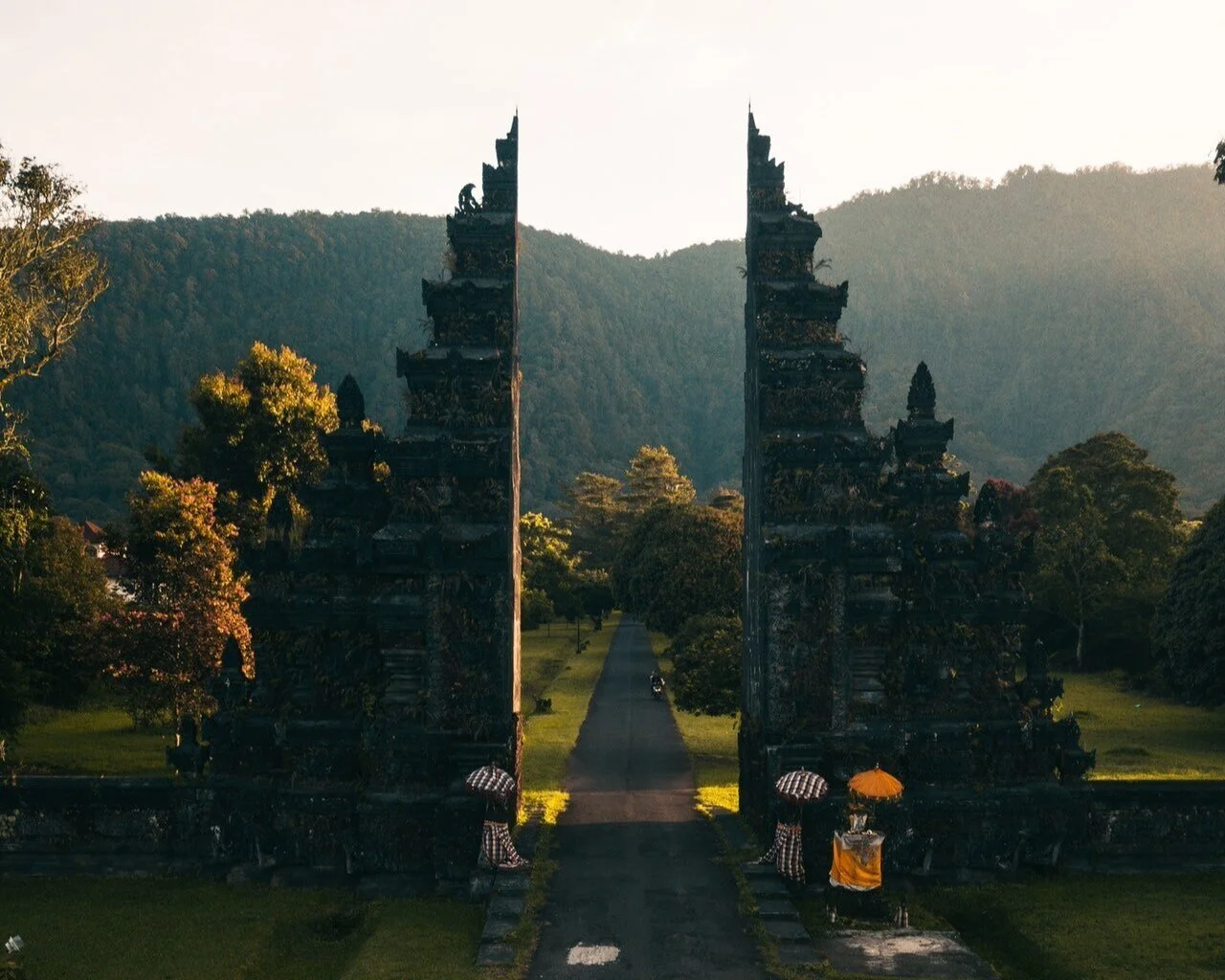 Photo of stone gate with green lush ridge in background by Stijn Dijkstra from Pexels
