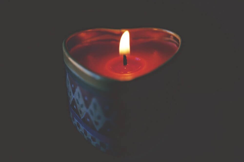 Photo of red candle in a heart shaped tin by George Becker from Pexels