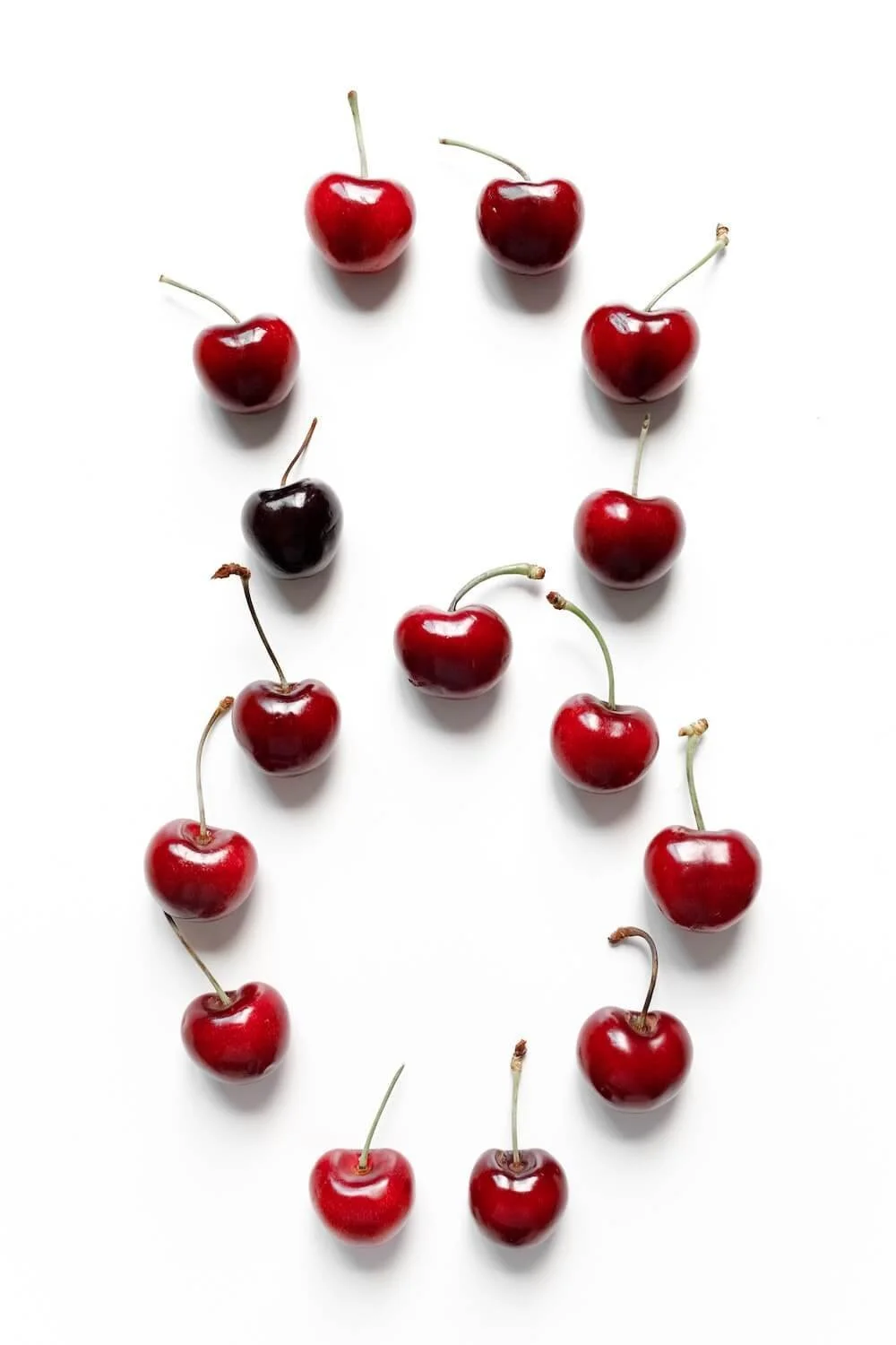 Photo of cherries in number 8 shape on white background by Nataliya Vaitkevich on Pexels