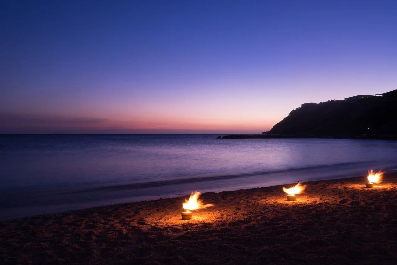 Photo of three flames on beach by Edwin Danen from Pixabay