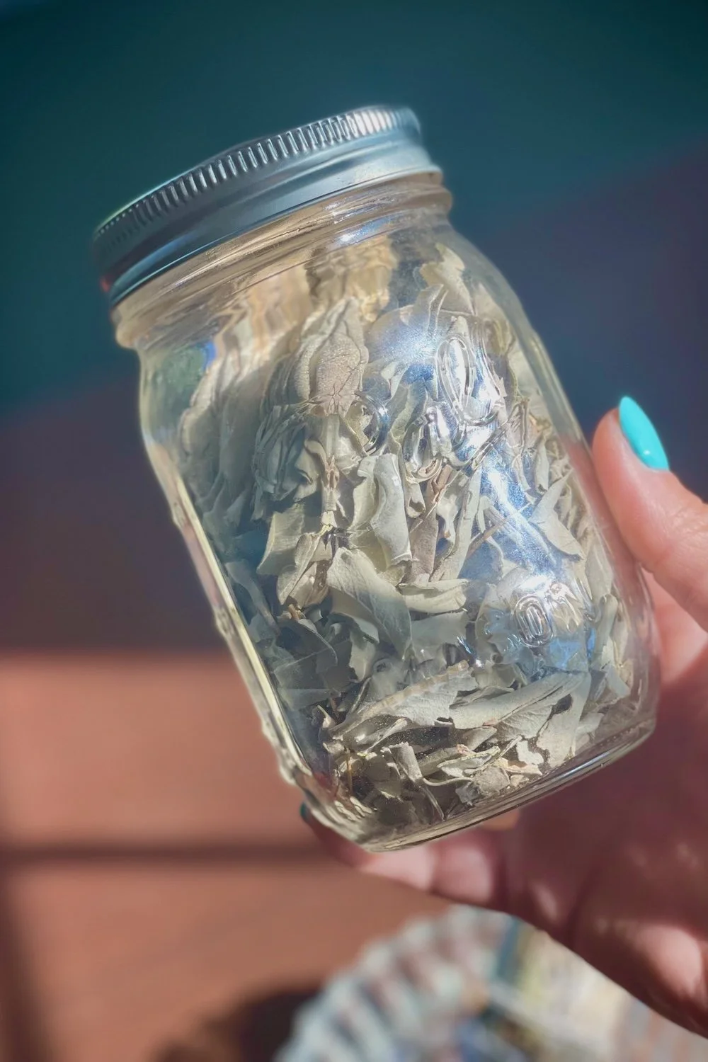 Jar of white sage leaves by Amanda Linette Meder