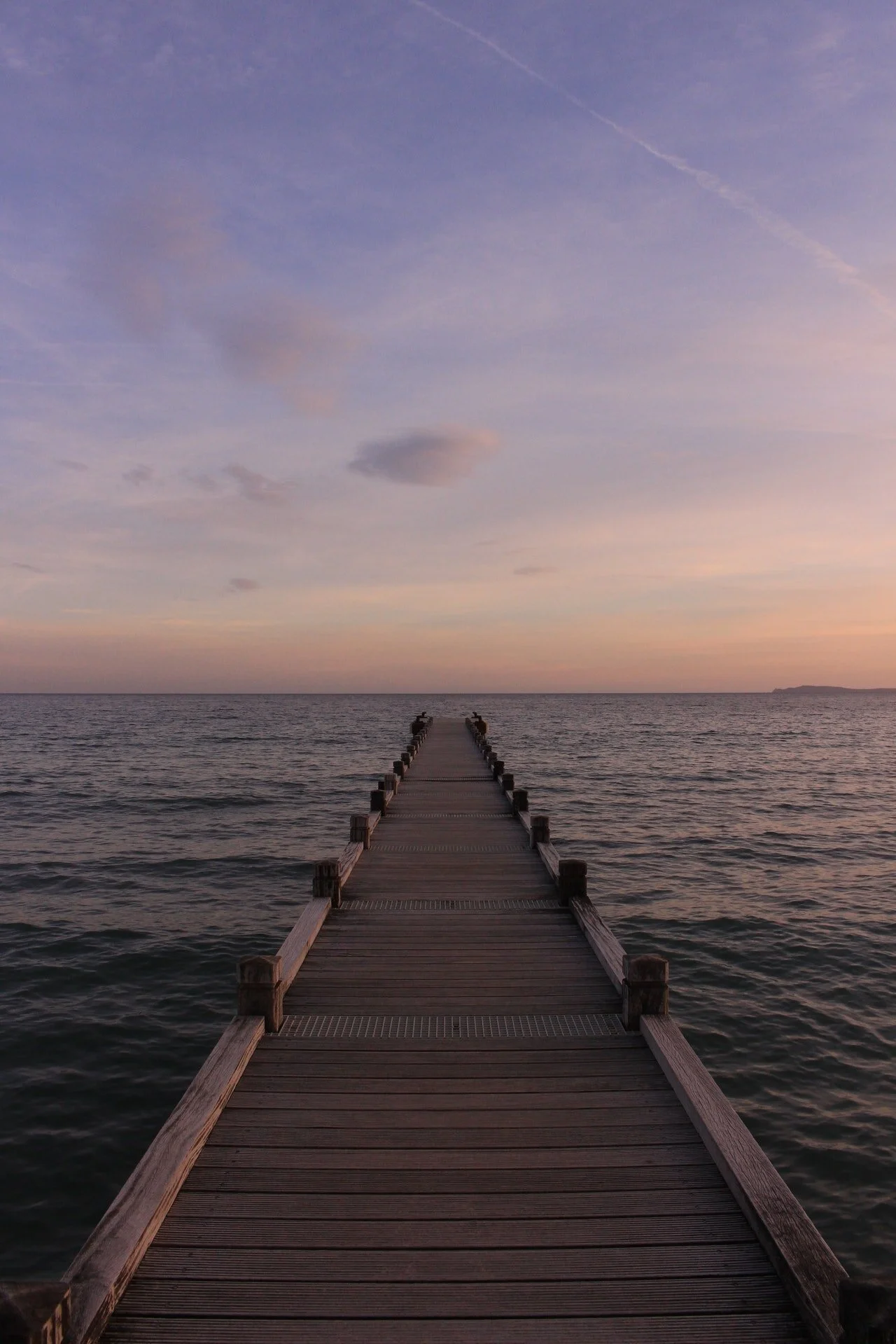 Photo of dock going out into the water at twilight by Pixabay from Pexels