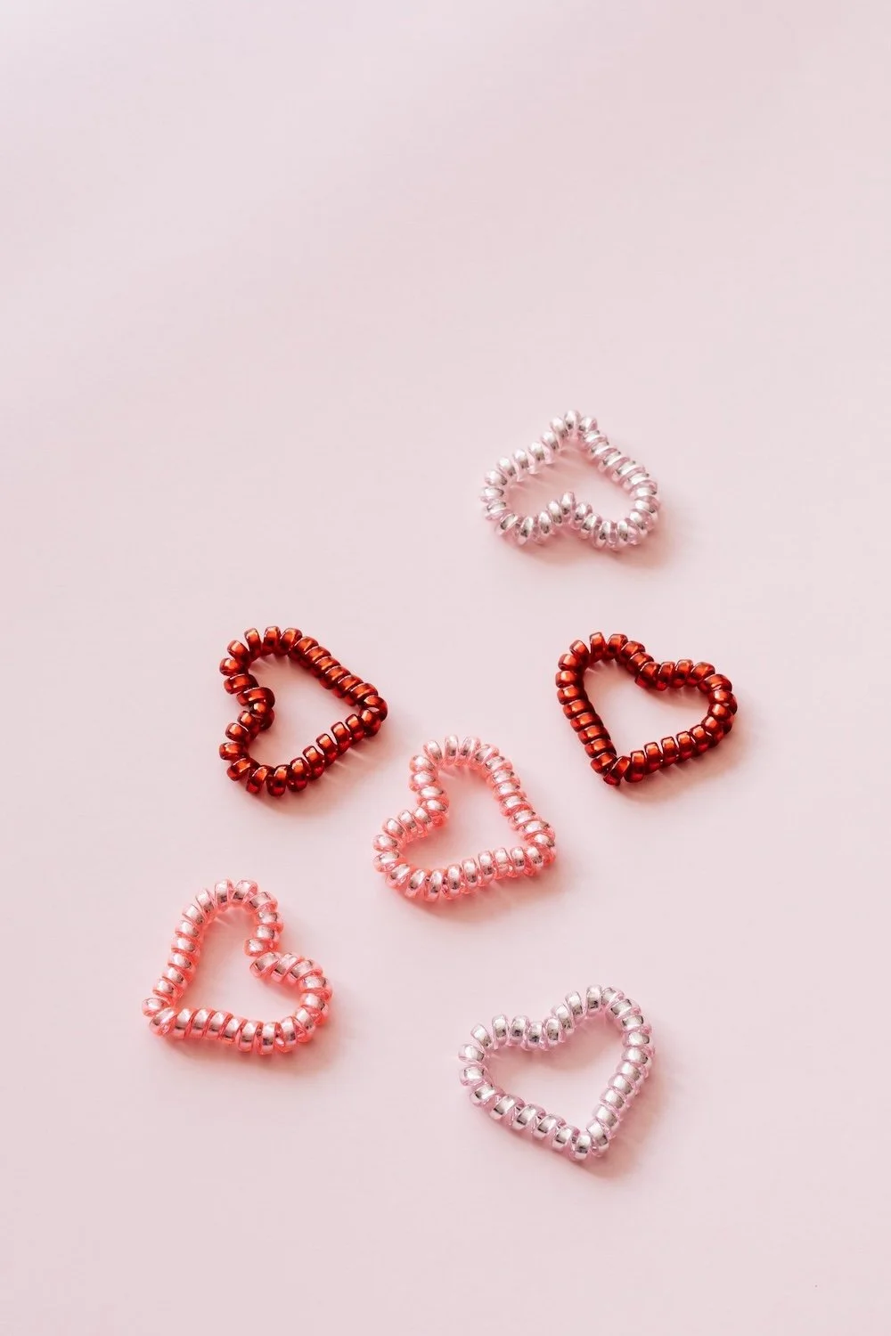 Vertical photo of six scattered heart shaped coils by Karolina Grabowska from Pexels