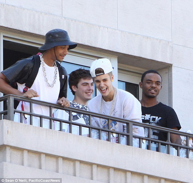 Bieber's friends look on in laughter. 