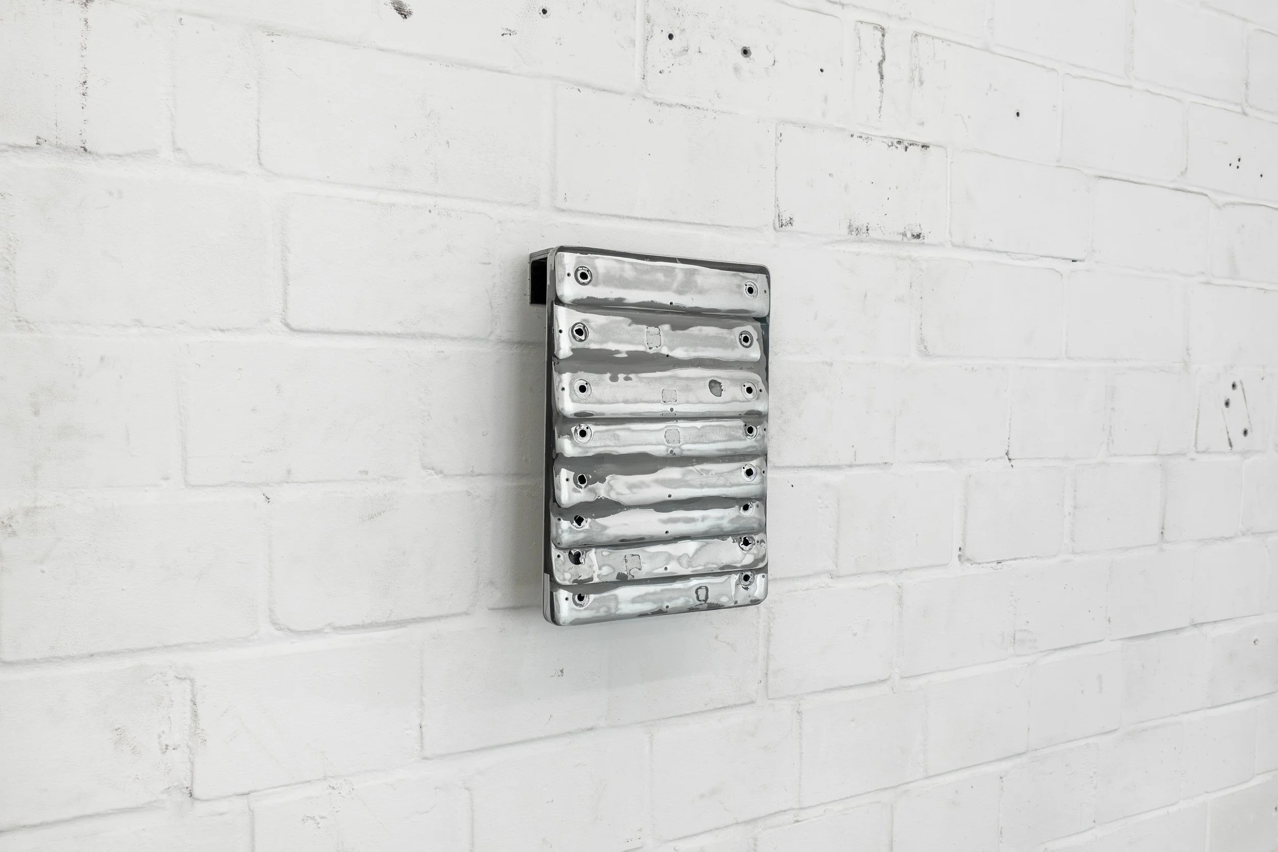 JASON GRINGLER. EBAY SCULPTURE (LAPTOPS) (2025). STUDIO VIEW. LAPTOPS, ALUMINUM, STEEL, EPOXY PUTTY, AUTOBODY FILLER, HARDWARE. 32.5 X 22.5 X 7 CM (13 X 9 X 3 IN) UNIQUE.