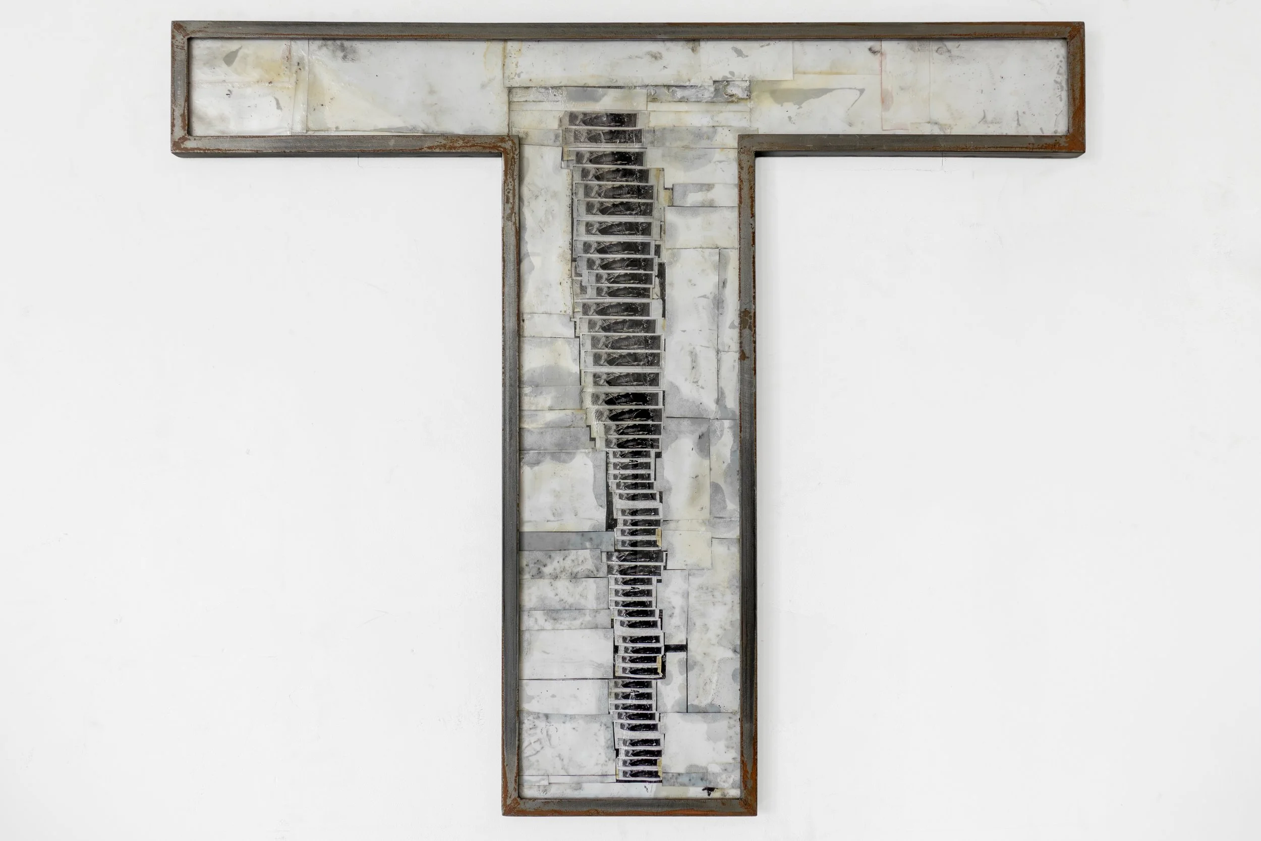  JASON GRINGLER.  PHOTO (26) (2026).  STUDIO VIEW.  PHOTOS, RUST PREVENTION OIL, PIGMENT, STEEL, ALUMINUM TAPE, ADHESIVES COLLAGE, ACRYLIC GLASS, RUST.  37 X 30.5 CM (14.5 X 12 IN) UNIQUE. 