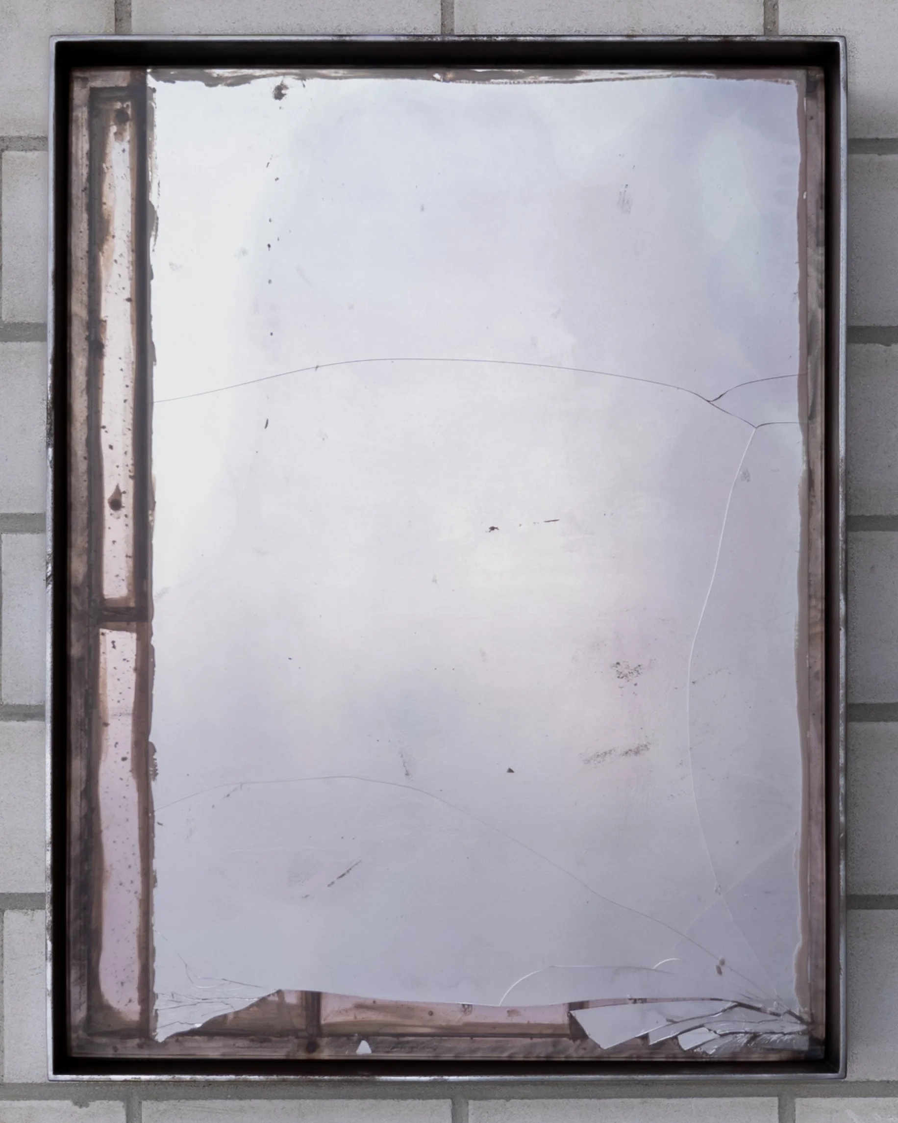  JASON GRINGLER.  (DEFACED) MONOCHROME (24) (2018-2026).  'AIR SERVICE' LO BRUTTO STAHL, BASEL. JUNE 15 - JUNE 21 2026.  STEEL, ADHESIVES, PIGMENT, MIRRORED GLASS, PLEXIGLAS, EPOXY, RUST, DETRITUS, WAX.  20 X 59.5 X 79 CM. 