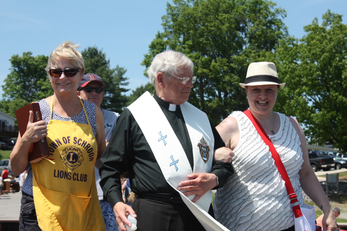 Anne Gregson, a local Priest and Shelby Davis at the Blessing of the Fleet