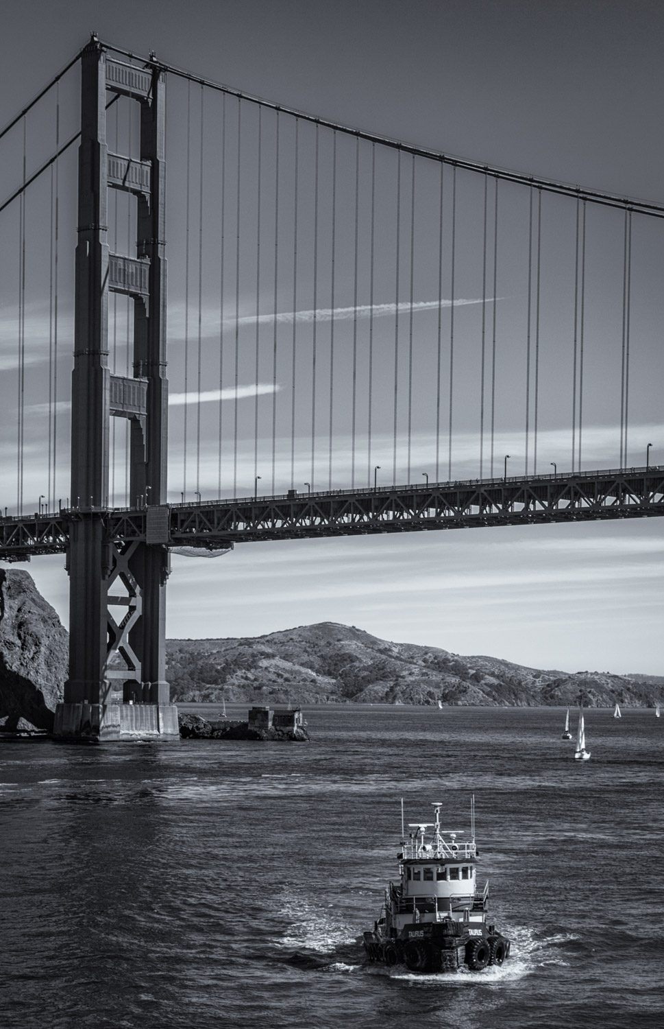 The tug Taurus sheperds the USS Jeremiah O'Brien under the Golden Gate Bridge.